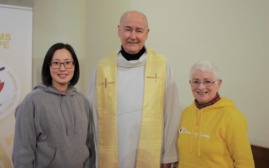Fr Kevin Mowbray with members of the liturgy group Inhae Park (left) and Jayne Sutherland (right).