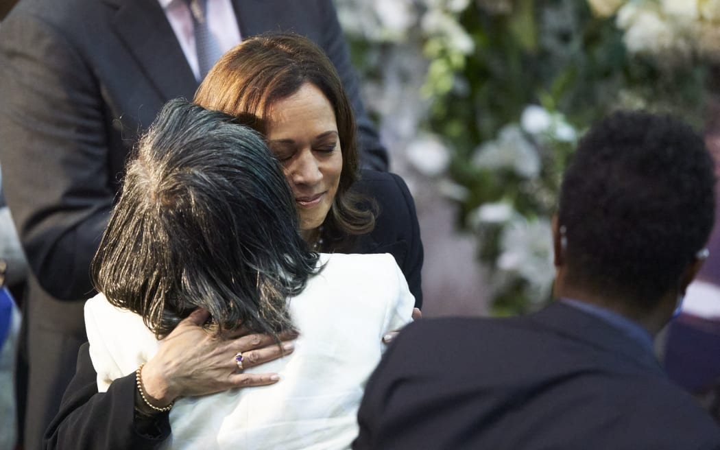 US Vice President Kamala Harris hugs Robin Harris, daughter of shooting victim Ruth Whitfield during her funeral service at Mount Olive Baptist Church in Buffalo, New York, on May 28, 2022. - Whitfield, 86, was killed in the racially motivated May 14 Buffalo mass shooting at Tops Friendly Market. She was the oldest of 10 people killed. (Photo by Geoff Robins / AFP)