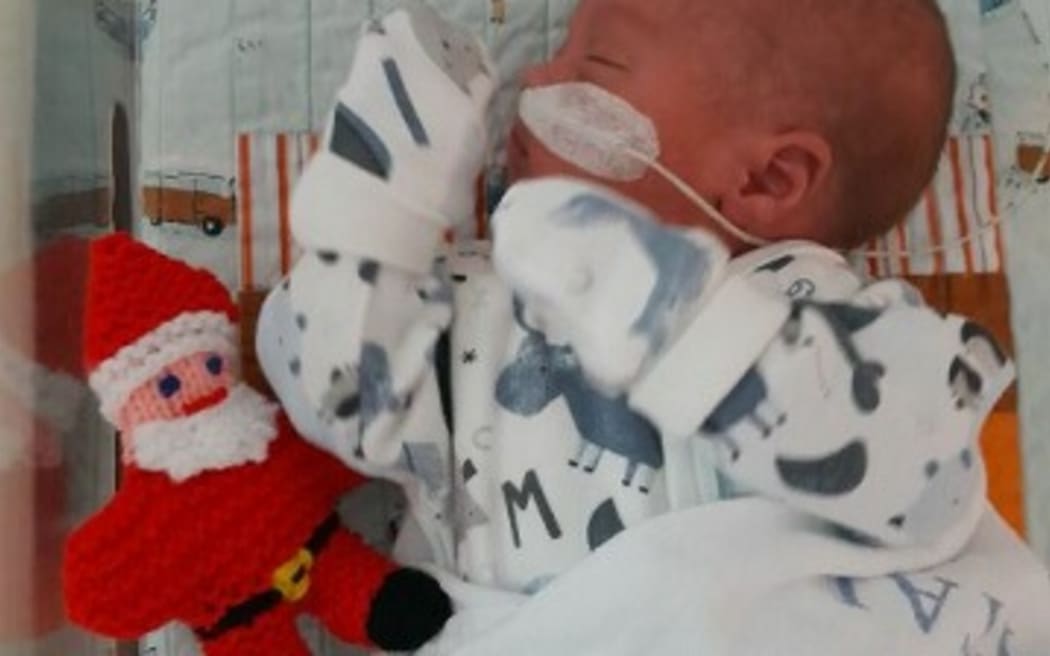 Baby Zycarrio-Colin, one of many babies in NICU with a new Christmas friend.