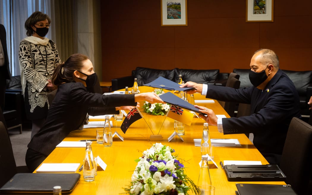 Premier of Niue Dalton Tagelagi signing documents with New Zealand Prime Minister Jacinda Ardern