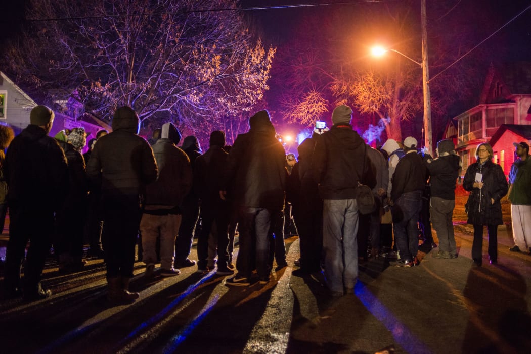 A group gathers in front of a police line after 5 people were shot at a Black Lives Matters protest November 24, 2015 in Minneapolis, Minnesota.