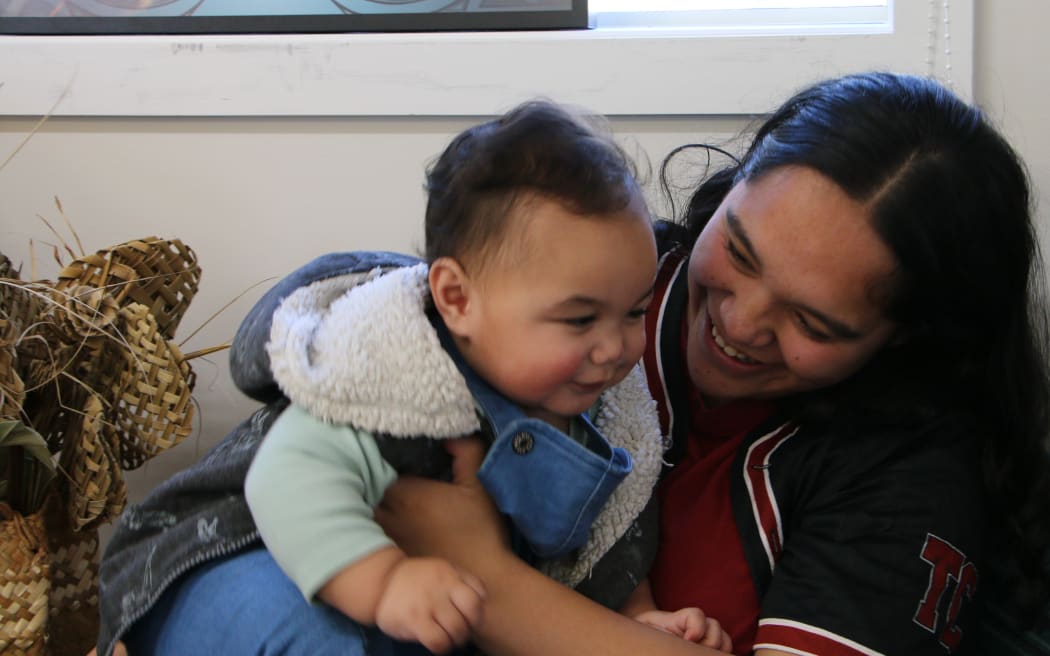 Katrina Kepa and her 10-month-old son Jazahrn at the opening of Te Whare Piringa, a new iwi-led kaupapa Māori space offering dedicated support to mātua taiohi (young parents) and whānau.