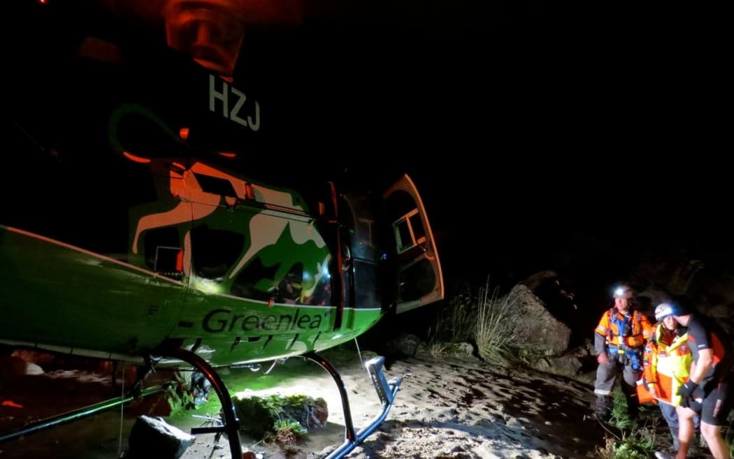 The kayaker is helped to the helicopter.