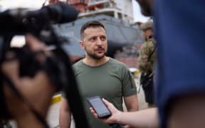 This handout picture taken and released by the Ukrainian Presidential Press Service on 29 July, 2022, shows President Volodymyr Zelensky facing journalists during a visit to Black Sea port of Chornomorsk ahead of the first anticipated export of grain under a deal with Russia.