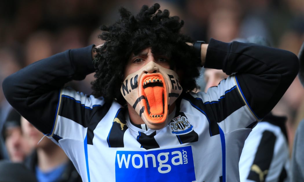 Premier League - A Newcastle fan wearing an angry mask.