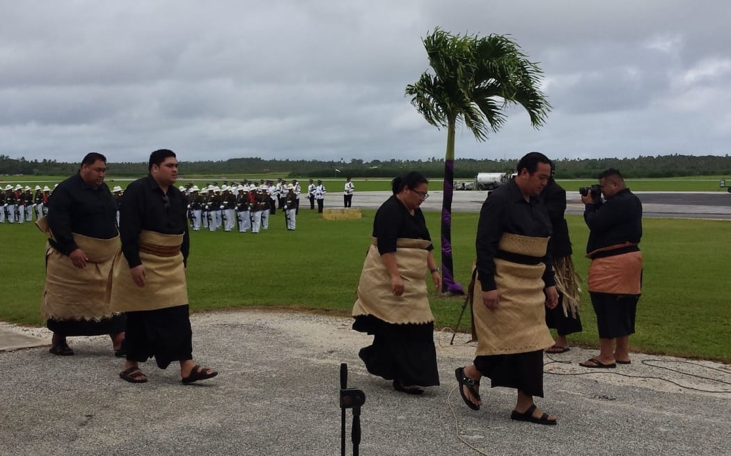 Tonga's Crown Prince Tupouto'a ‘Ulukalala, (right), leads members of the royal family to welcome the body of Queen Mother Mata'aho home