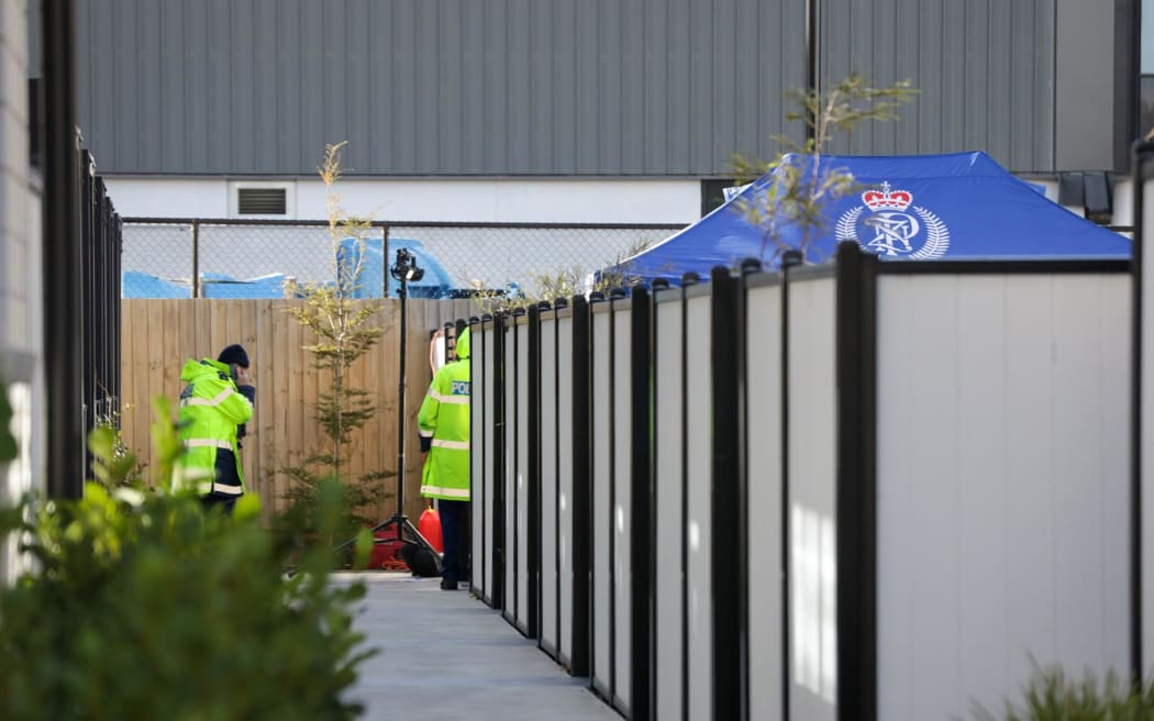 Police set up a blue specialist search group tent in the front yard of a Christchurch apartment as they investigate the disappearance of Ping Lyu, 41, who was last seen on Saturday.