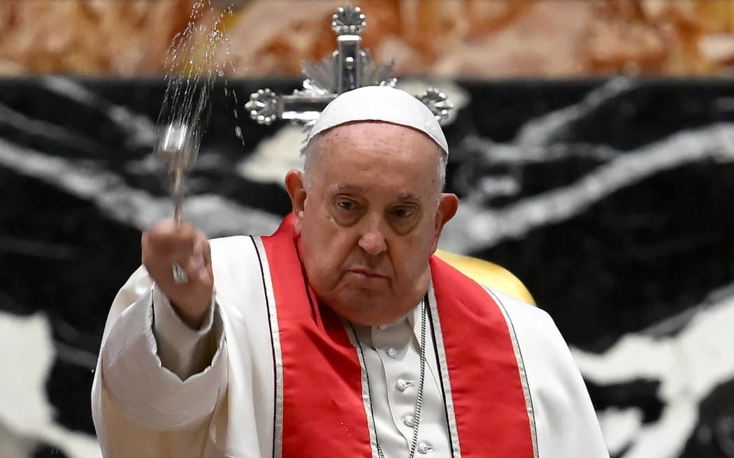 Pope Francis (C) presides over the funeral of Italian Cardinal Sergio Sebastiani at the altar of the Chair in St. Peter's Basilica in the Vatican, on January 17, 2024. (Photo by Filippo MONTEFORTE / AFP)