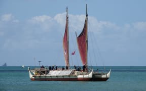 The wa’a (waka) Hōkūle’a anchors in Tii Bay.
