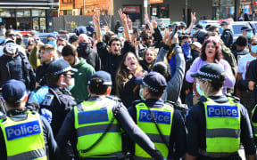 Anti-lockdown protesters chant slogans at Melbourne's Queen Victoria Market during a rally on 13 September