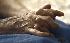 Old woman's hands clasped.