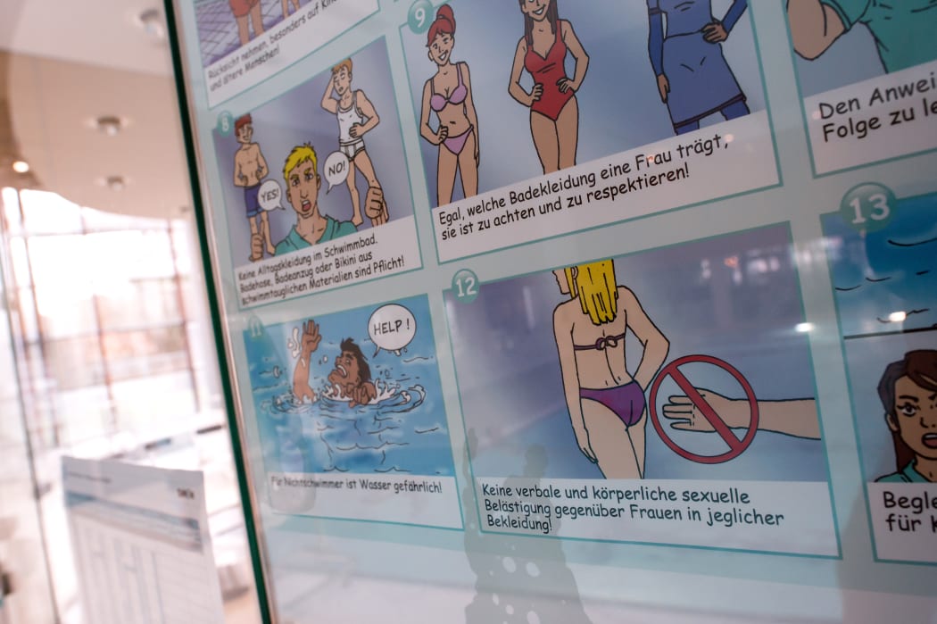 A poster informs about pool rules in a public swimming pool in Germany.