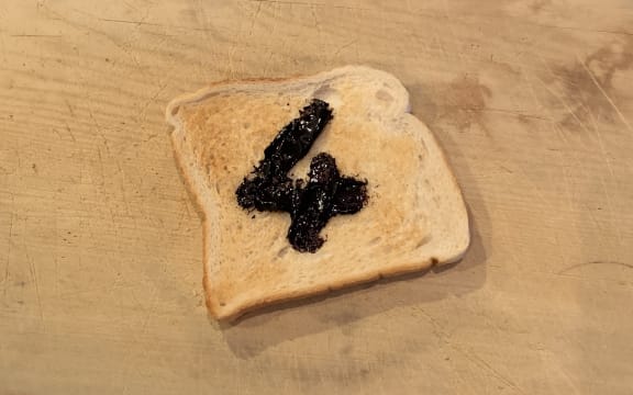 Toast with marmite spread on it to form the number 4