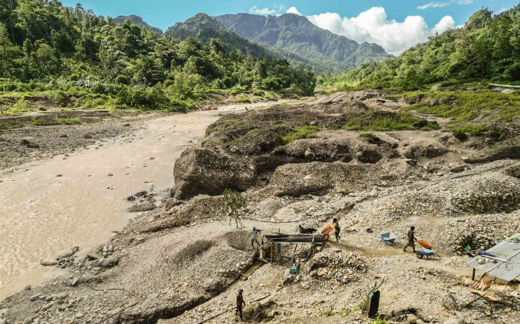 Artisanal miners search for gold in the waters downstream from the Panguna mine in Bougainville, Papua New Guinea.