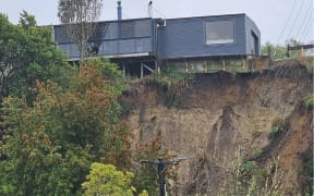 Modern house perched on the edge above a slip