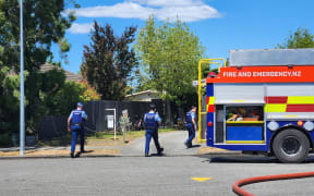 Two police cars and two fire trucks are at the scene of a house fire in the Christchurch suburb of Hornby.