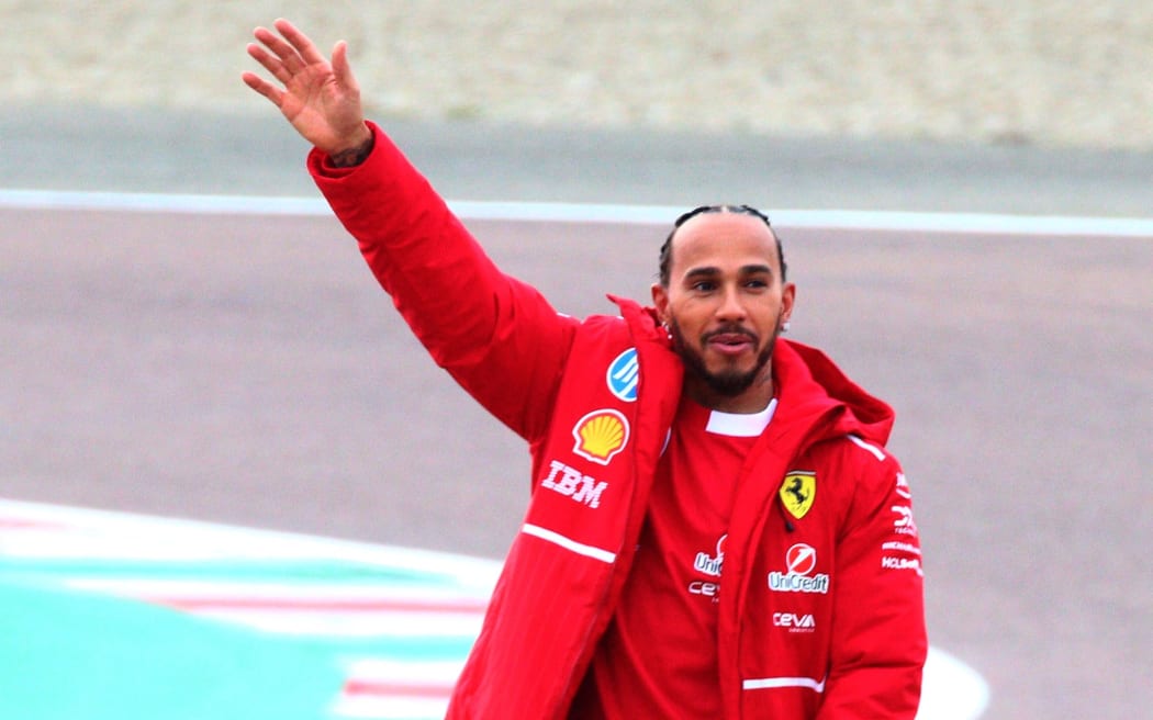 Lewis Hamilton waves to fans and supporters