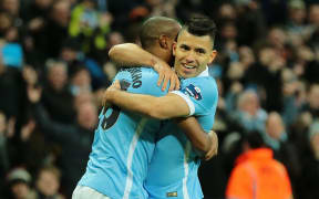 Manchester City forward Sergio Agüero celebrates with Manchester City midfielder Fernandinho.