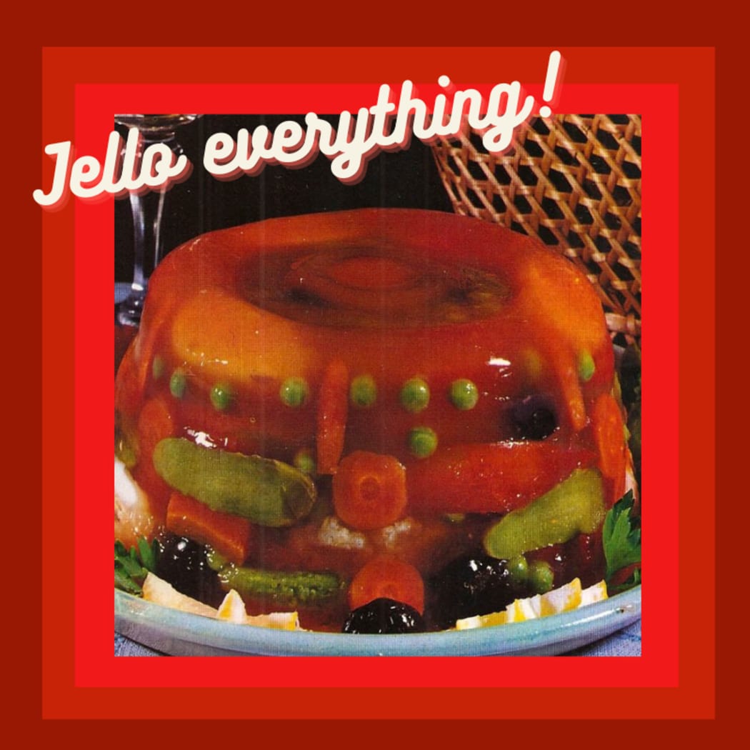 A photo of a platter with a large mound of vegetables encased in jelly. It's hard to make out eveything that might be in the jelly but peas and carrots are definitely involved. The imaged is framed in 70s colours and captioned "Jello everything!"