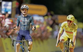 Danish rider Jonas Vingegaard (L) cycles to the finish line to win stage 11 of the Tour de France ahead of Slovenian rider Tadej Pogacar.