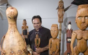 Artist James Webster with seven carved kareatao.