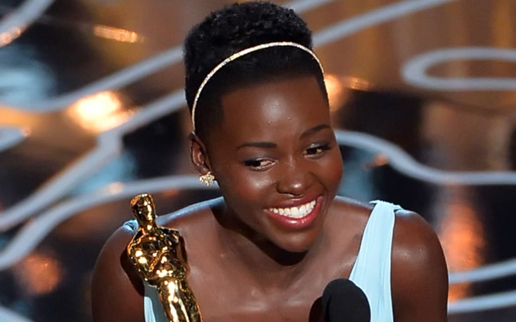 Lupita Nyong'o accepts the Oscar for best supporting actress for 12 Years a Slave.