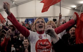 Anti-austerity Syriza supporters celebrate at the Syriza election kiosk in Athens in January 2015.