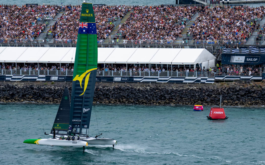 Australia SailGP Team helmed by Tom Slingsby head towards the finish marker in front of a sold out grandstand of spectators to win the final race on Race Day 2 of The Rolex SailGP 2025 Championship ITM New Zealand Sail Grand Prix in Auckland, New Zealand. Sunday 19 January 2025. Photo: Bob Martin for SailGP. Handout image supplied by SailGP