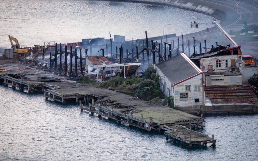 Fire crews dampen down the site of a blaze in a warehouse at Shelly Bay, Wellington.