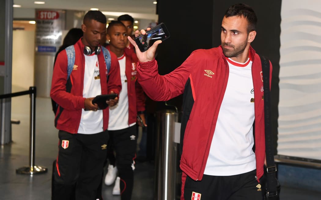 Peru football goalkeeper Jose Carvallo waves to fans as the team touches down in New Zealand.