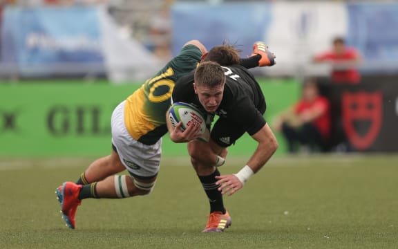 Fergus Burke of New Zealand is tackled by James Mollentze of South Africa during the World Rugby U20 Championship match.