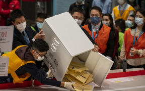 Officials empty a ballot box following the Legislative Council General Election in Hong Kong.