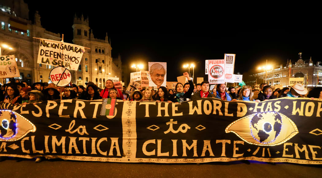 Demonstrators take part in the climate march on the fringes of the world climate conference.