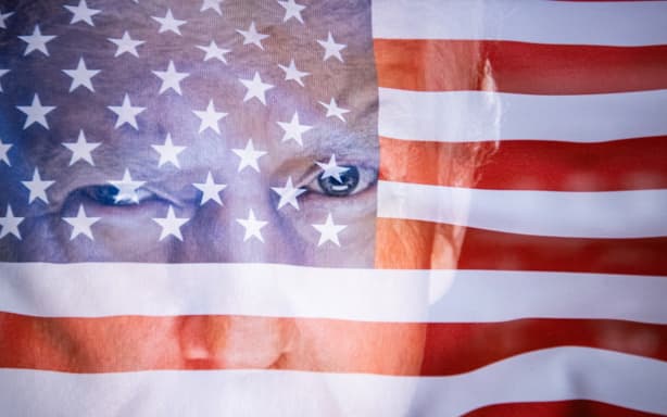 Double exposure photograph of the United States flag and the official portrait of their president Donald Trump at Kerlouan in Brittany in France on August 12 2025. (Photo by Vincent Feuray / Hans Lucas via AFP)