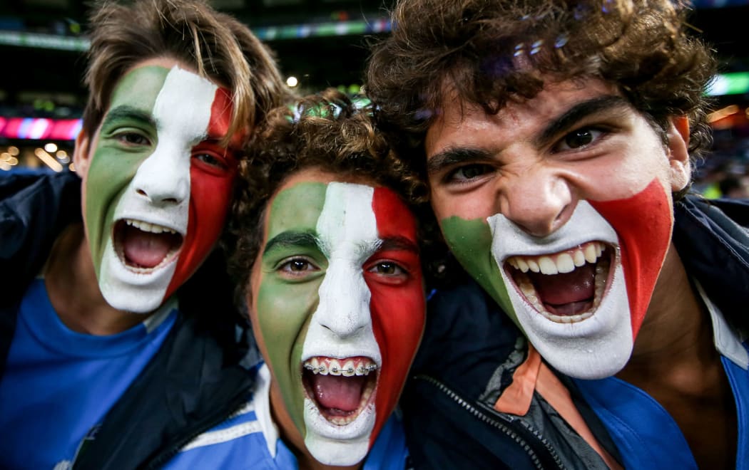 Italy rugby fans cheer on their team.