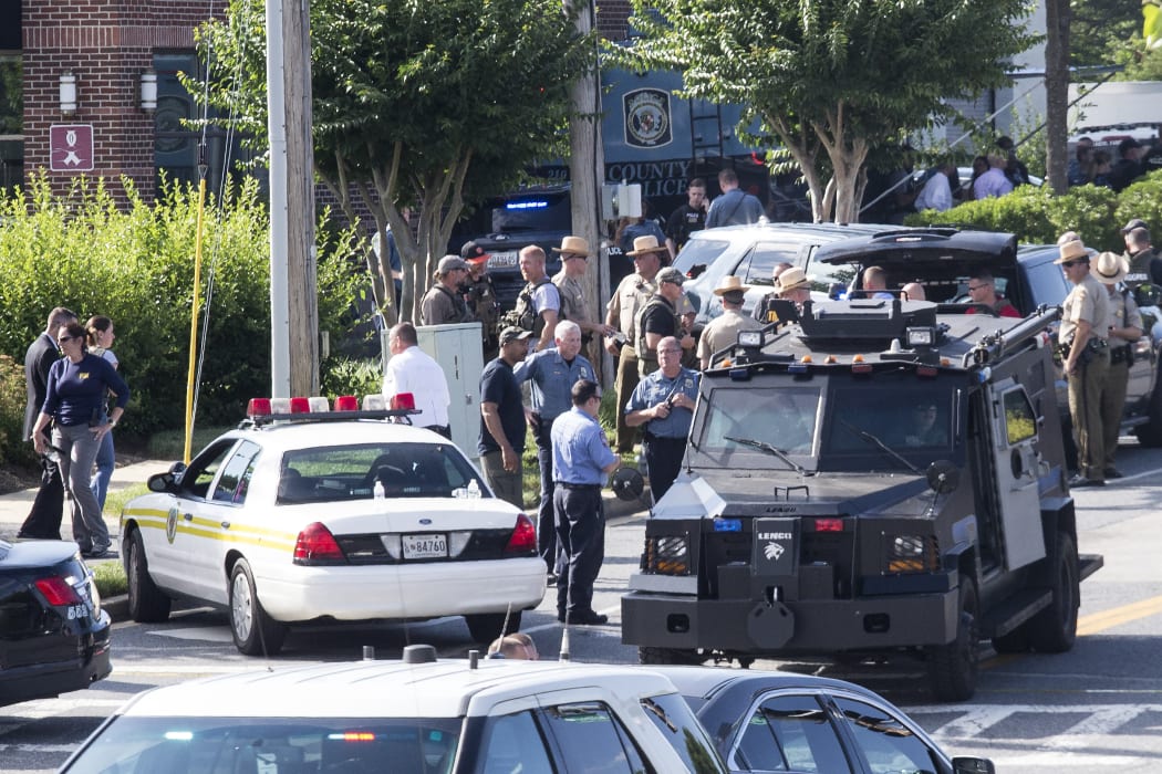 Police respond to a shooting in Annapolis, Maryland where at least five people were killed when a gunman opened fire inside the offices of the Capital Gazette newspaper.