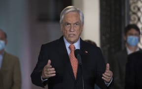 Chile's President Sebastian Pinera speaks at La Moneda presidential palace, in Santiago on October 25, 2020 following the results of the constitutional referendum voting.