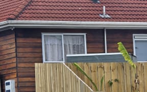 A house that had its window broken after gunshots were fired in the Auckland suburb of Point England.