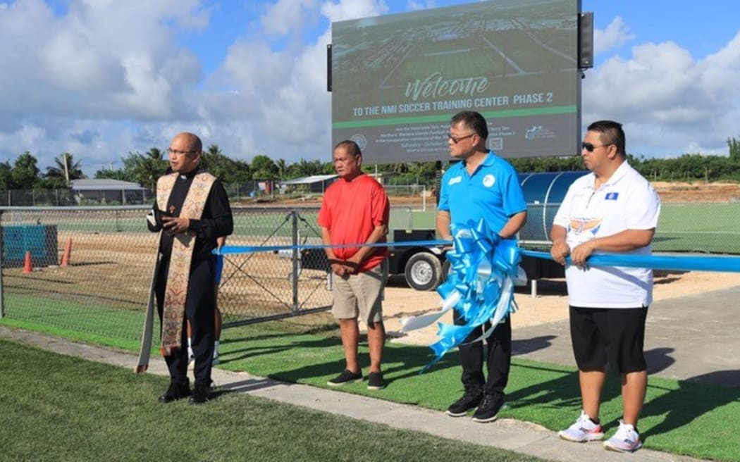 NMIFA president Jerry Tan, second from right, joins Governor Ralph Torres, right, in the ribbon-cutting ceremony for the second world-class soccer pitch of the CNMI.