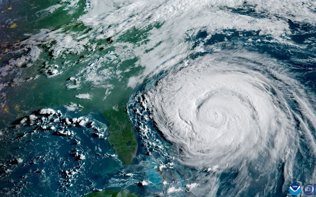 This satellite image provided by the National Oceanic and Atmospheric Administration (NOAA) shows Hurricane Erin looming of the US East Coast on August 20, 2025.