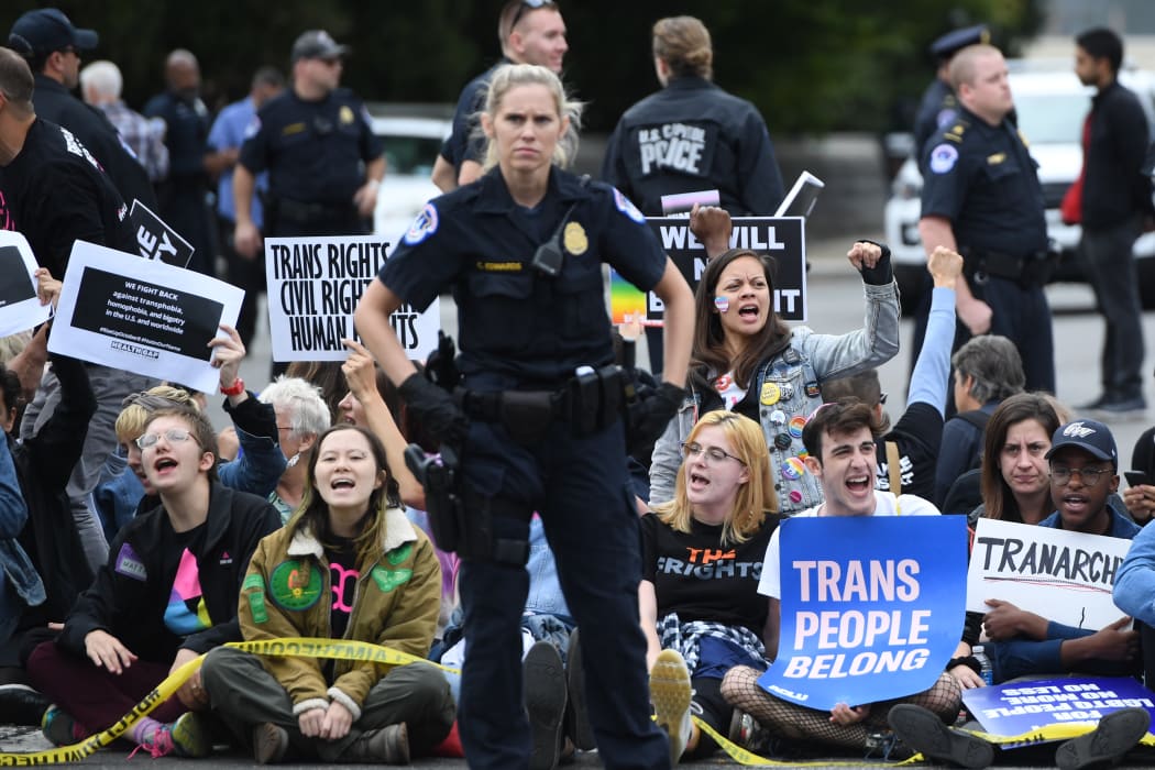 Demonstrators in favour of LGBT rights do a sit-in as they rally outside the US Supreme Court in Washington, DC, October 8, 2019, as the Court holds oral arguments in three cases dealing with workplace discrimination based on sexual orientation. (Photo by SAUL LOEB / AFP)