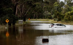 A car floats in floodwaters along the Hawkesbury River in suburban Sydney on March 3, 2022. (