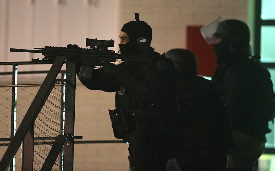 Police are seen during the operation in Reims, northern France, following the attack in Paris that left 12 dead.