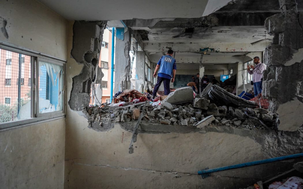 A member of the United Nations checks a UN-school housing displaced people that was hit during Israeli bombardment in Nuseirat, in the central Gaza Strip, on 6 June, 2024.