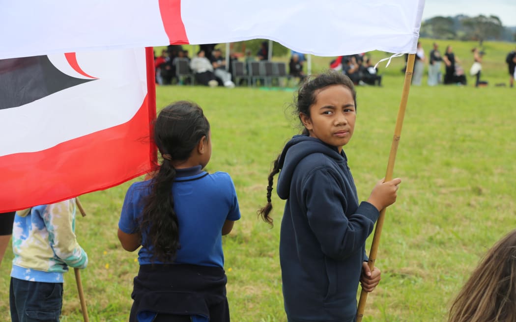 Crowds await hīkoi at Ihumātao.