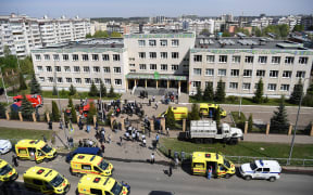 Police and paramedics work at the scene of a shooting at Gymnasium No. 175 in Kazan.