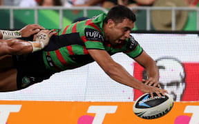 The Rabbitohs wing Alex Johnston dives over for a try.