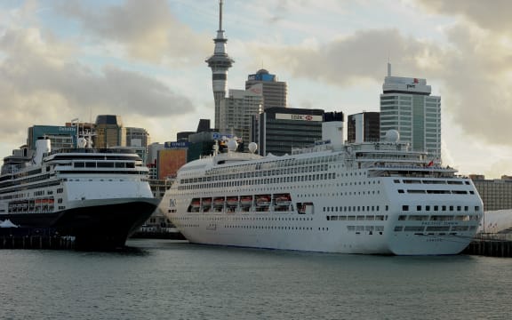 Cruise ships (C) lie tied up at Auckland's Viaduct Harbour during the 2011 Rugby World Cup on October 14, 2011. Auckland in New Zealand's North Island has the largest urban area in the country with just over one million people living there.  AFP PHOTO / Greg WOOD (Photo by GREG WOOD / AFP)