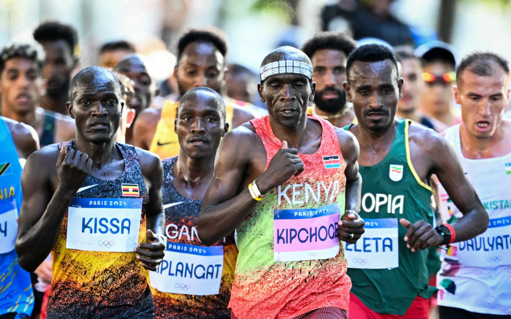 Kenya's Eliud Kipchoge and other athletes compete in the men's marathon of the athletics event at the Paris 2024 Olympic Games in Paris on August 10, 2024. (Photo by Kirill KUDRYAVTSEV / AFP)