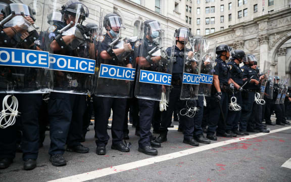 Police officers stand guard during Black Lives Matter protest as protesters locked down the streets by New York's City Hall and Police Plaza.
